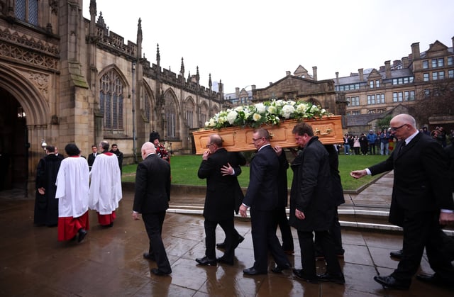 Soccer Football - Funeral of former Scotland and Manchester United footballer Denis Law - Manchester Cathedral, Manchester, Britain - February 11, 2025 The coffin of Denis Law is carried into Manchester Cathedral Action Images via Reuters/Ed Sykes