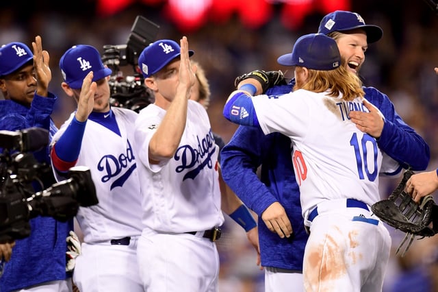 Clayton Kershaw #22 celebrates with Justin Turner #10 of the Los Angeles Dodgers after defeating the Houston Astros 3-1 in game one of the 2017 World Series at Dodger Stadium on October 24, 2017 in Los Angeles.
