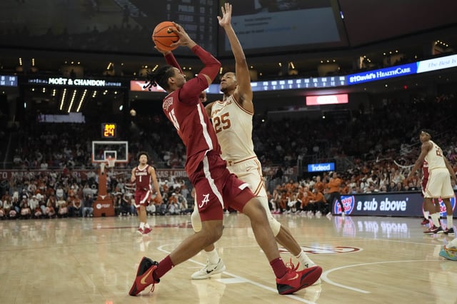 Feb 11, 2025; Austin, Texas, USA; Alabama Crimson Tide forward Jarin Stevenson (15) drives to the basket against Texas Longhorns forward Jayson Kent (25) during the second half at Moody Center. Mandatory Credit: Scott Wachter-Imagn Images