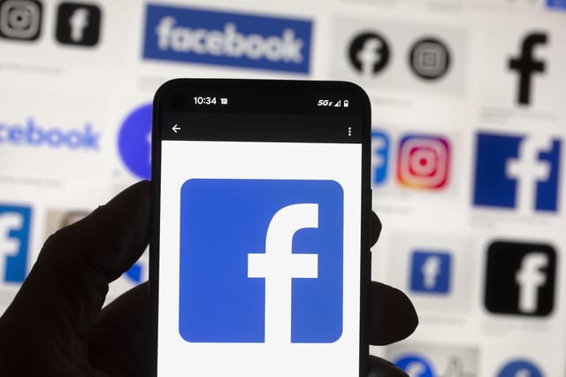 FILE - The Facebook logo is seen on a cell phone in Boston, USA, Oct. 14, 2022. (AP Photo/Michael Dwyer, File)