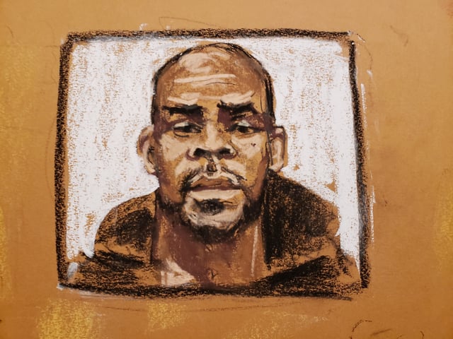 An image of R. Kelly is shown on a screen as Cheryl Mack is questioned by Assistant U.S. Attorney Nadia Shihata during Kelly's sex abuse trial at Brooklyn's Federal District Court in a courtroom sketch in New York, U.S., September 17, 2021. REUTERS/Jane Rosenberg/File Photo