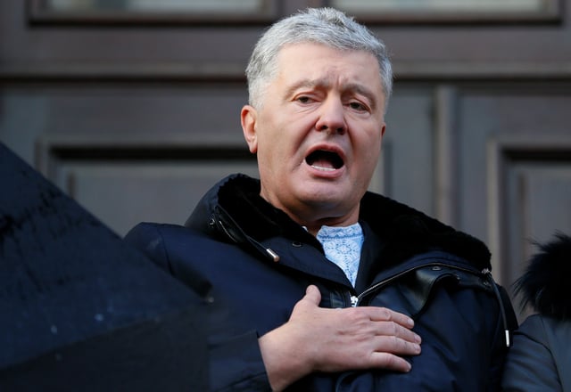 Ukrainian former President Petro Poroshenko, who is suspected of high treason by financing pro-Russian separatists in eastern Ukraine while in office in 2014-2015, sings the national anthem after a court hearing in Kyiv, Ukraine January 19, 2022. REUTERS/Gleb Garanich/File photo