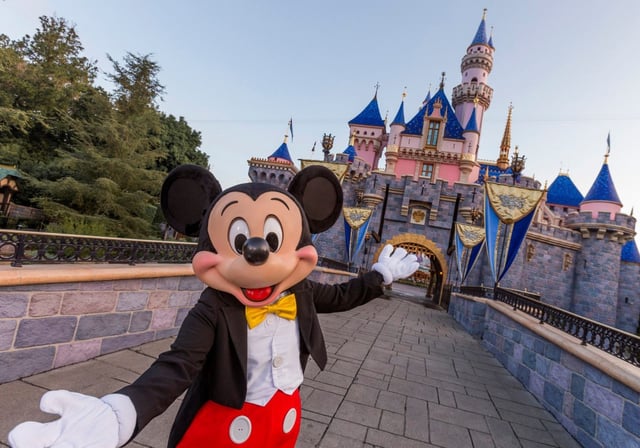 Mickey Mouse poses in front of Sleeping Beauty Castle at Disneyland Park on August 27, 2019 in Anaheim, California.