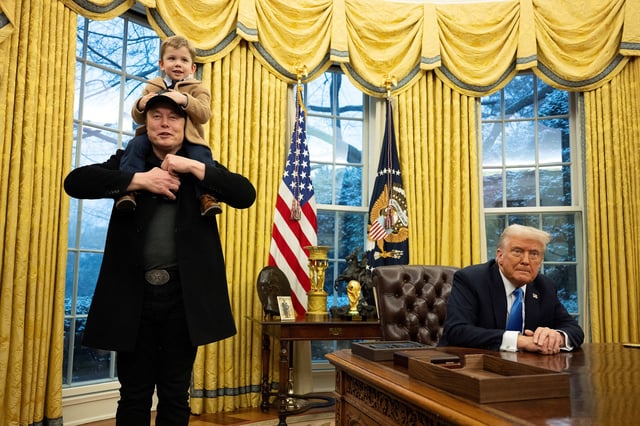 Elon Musk carries his son X Æ A-Xii on his shoulders while speaking as US President Donald Trump looks on in the Oval Office of the White House.