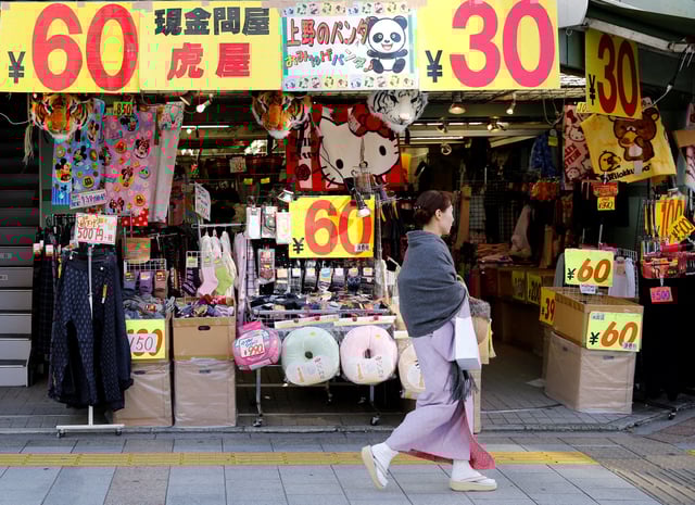 A woman in kimono, walks past a shop in a shopping district in Tokyo, Japan, November 29, 2016.  REUTERS/Toru Hanai/File Photo