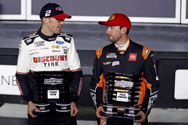 Feb 12, 2025; Daytona Beach, Florida, USA; NASCAR Cup Series driver Austin Cindric (2) celebrates with the front row trophy and NASCAR Cup Series driver Chase Briscoe (19) celebrates with the pole award after qualifying for the Daytona 500 at Daytona International Speedway. Mandatory Credit: Peter Casey-Imagn Images