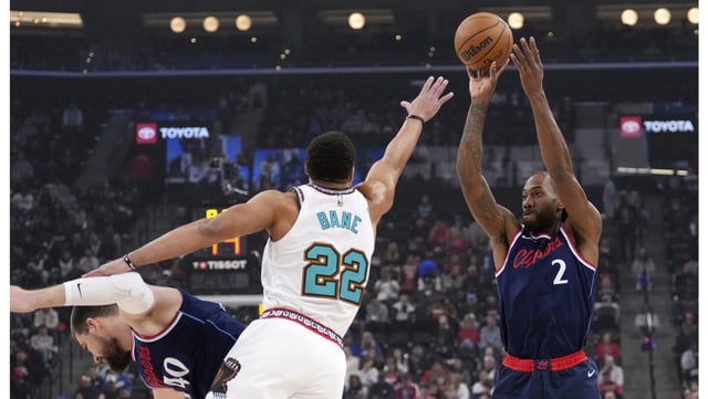 Clippers star Kawhi Leonard, right, shoots as Memphis Grizzlies guard Desmond Bane, center, defends and center Ivica Zubac gets knocked away during the first half on Wednesday night at the Intuit Dome in Inglewood. (AP Photo/Mark J. Terrill)