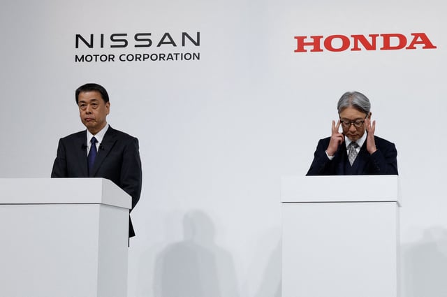 Makoto Uchida, Director, Representative Executive Officer, President and CEO of Nissan Motor Corporation and Toshihiro Mibe, Director, President and Representative Executive Officer of Honda, hold a joint press conference on their merger talks, in Tokyo, Japan, December 23, 2024. REUTERS/Kim Kyung-Hoon/File Photo