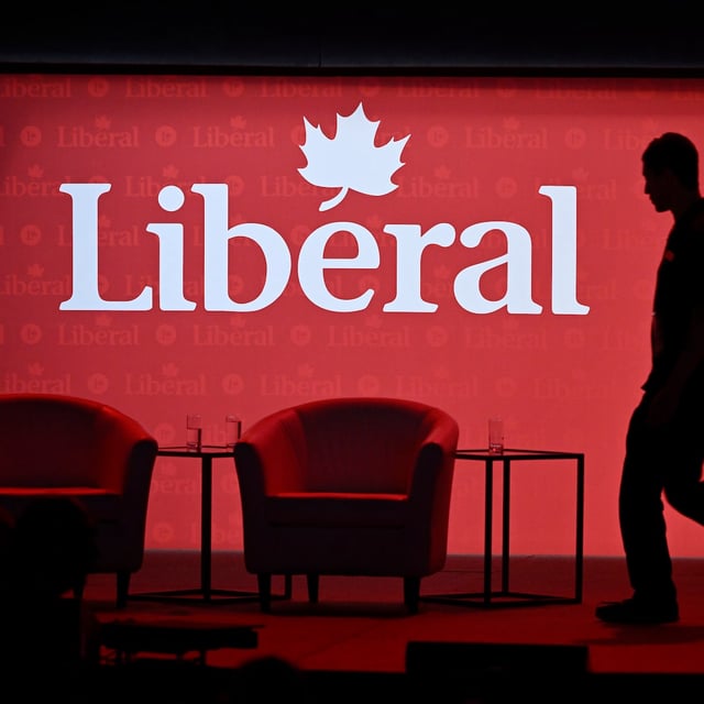 A stagehand works on the stage in between presenters at the 2023 Liberal National Convention in Ottawa, on Thursday, May 4, 2023. THE CANADIAN PRESS/Justin Tang