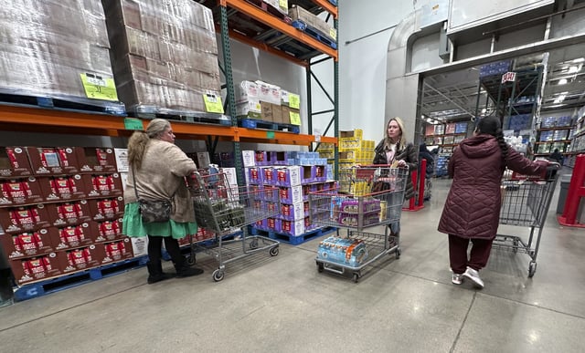 FILE - Shoppers guide their carts through the milk display in a Costco warehouse Thursday, Jan. 23, 2025, in Sheridan, Colo. (AP Photo/David Zalubowski)