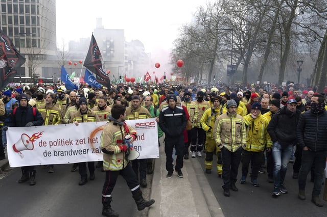 Firemen march with other protestors during a national demonstration to protest against federal spending cuts in Brussels, Thursday, Feb. 13, 2025. (AP Photo/Marius Burgelman)
