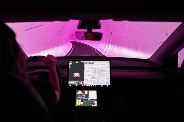 A Tesla Inc. electric vehicle is driven through a tunnel in the Boring Company&#39;s Las Vegas Convention Center Loop during the Consumer Electronics Show (CES) in Las Vegas, Nevada, on January 5, 2023.
