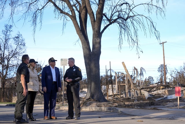 FILE - President Donald Trump and first lady Melania Trump walk with Jason Hing, chief deputy of emergency services at the Los Angles Fire Department, left, and Capt. Jeff Brown, chief of Station 69, as they tour the Pacific Palisades neighborhood affected by recent wildfires in Los Angeles, Jan. 24, 2025. (AP Photo/Mark Schiefelbein, File)