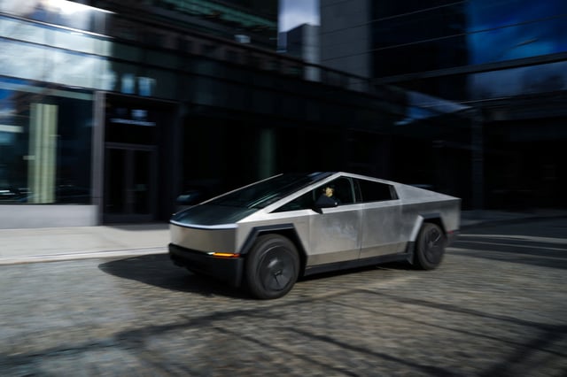 A Tesla Cybertruck drives outside of a Tesla showroom in New York City, U.S., January 2, 2025. REUTERS/Adam Gray/File Photo