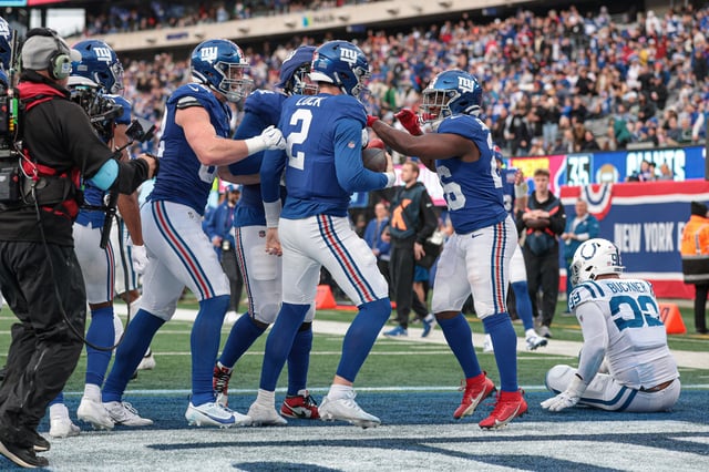Dec 29, 2024; East Rutherford, New Jersey, USA; New York Giants quarterback Drew Lock (2) celebrates with teammates after a rushing touchdown during the fourth quarter against the Indianapolis Colts at MetLife Stadium. Mandatory Credit: Vincent Carchietta-Imagn Images/File Photo