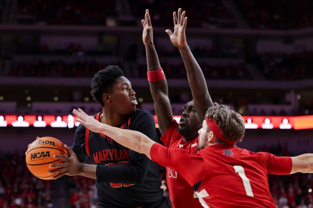 Maryland&#39;s Derik Queen (25) is guarded by Nebraska&#39;s Juwan Gary (4) and Sam Hoiberg (1) during the first half of an NCAA college basketball game, Thursday, Feb. 13, 2025, in Lincoln, Neb. (Nikos Frazier/Omaha World-Herald via AP)