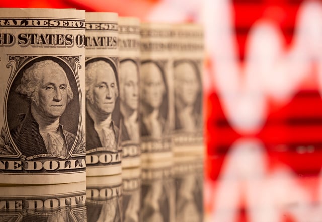 U.S. One dollar banknotes are seen in front of displayed stock graph in this illustration taken, February 8, 2021. REUTERS/Dado Ruvic/Illustration/File Photo