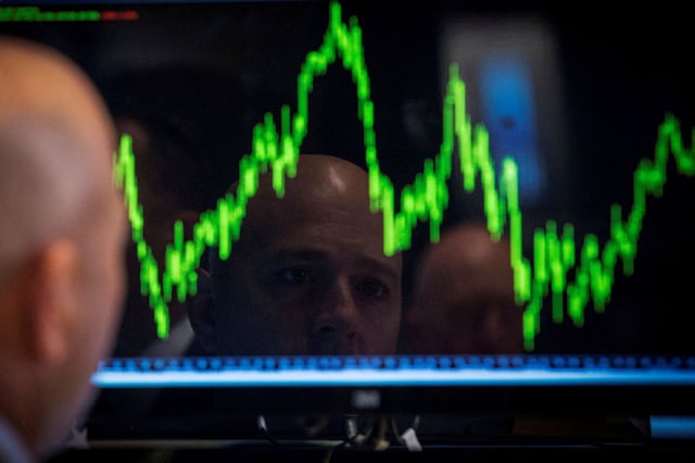 A trader watches his chart while working on the floor of the New York Stock Exchange July 8, 2014. REUTERS/Brendan McDermid/File Photo