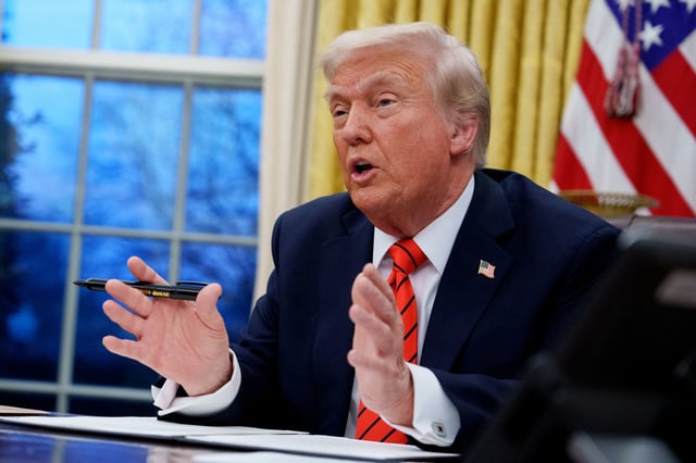 President Donald Trump signs a series of executive orders in the Oval Office of the White House on Feb. 10, 2025.