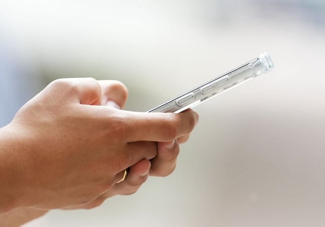 A person uses a cellphone in Ottawa on Monday, July 18, 2022. THE CANADIAN PRESS/Sean Kilpatrick