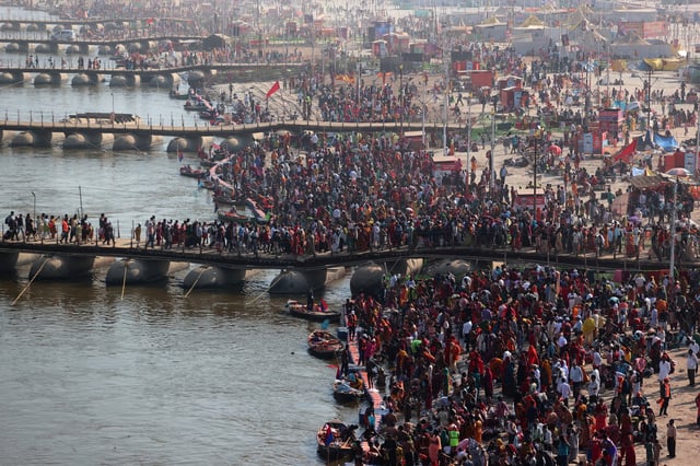 Devotees gather to take a dip at Sangam, the confluence of the Ganges and Yamuna rivers with the mythical invisible Saraswati river, to mark Maghi Purnima, one of the auspicious days during the "Maha Kumbh Mela", or the Great Pitcher Festival, in Prayagraj, India, February 12, 2025. REUTERS/Ritesh Shukla/File Photo