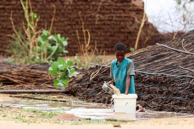 A displaced Sudanese child pours water at Zamzam camp, in North Darfur, Sudan, August 1, 2024. REUTERS/Mohamed Jamal Jebrel/File Photo