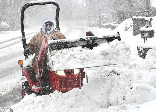 Matt Hodges plows snow from his driveway in Beckley, W.Va., Tuesday, Feb. 11, 2025. (Rick Barbero/The Register-Herald via AP)