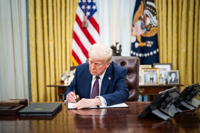 President Trump signs executive orders in the Oval Office at the White House on January 23, 2025, in Washington, D.C.
