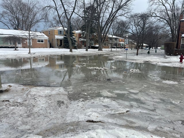 A water main break in Skokie flooded several areas, including Ewing Street. Residents said several garages were flooded, and Skokie and Evanston issued boil orders for drinking water. (Richard Requena/Pioneer Press)