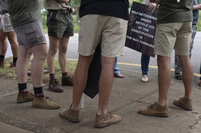 White South Africans demonstrate in support of U.S. President Donald Trump in front of the U.S. embassy in Pretoria, South Africa, Saturday, Feb. 15, 2025. (AP Photo/Jerome Delay)