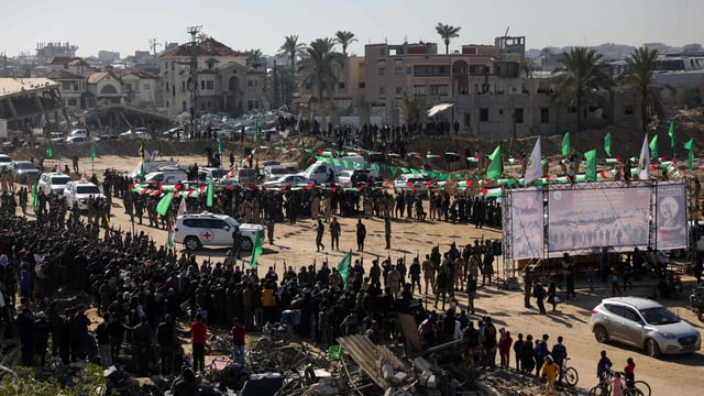 Red Cross vehicles enter an area secured by Palestinian Hamas fighters, before receiving Israeli hostages in Khan Yunis in the southern Gaza Strip on February 15, 2025.
