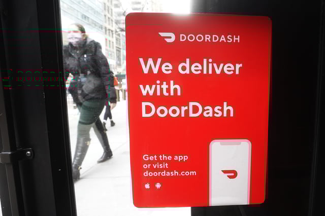 A DoorDash sign is pictured on a restaurant in the Manhattan borough of New York City, New York, U.S., December 9, 2020. REUTERS/Carlo Allegri/File Photo