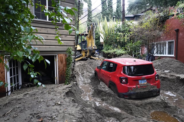 A vehicle is dug out of the mud after a storm Friday, Feb. 14, 2025, in Sierra Madre, Calif. (AP Photo/Damian Dovarganes)