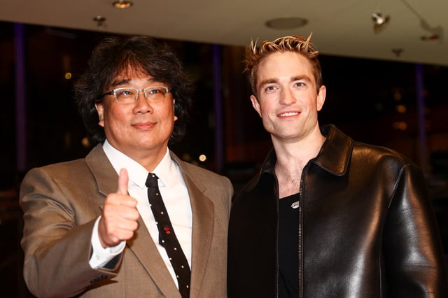 Director Joon-ho Bong and Robert Pattinson attend the screening of the movie "Mickey 17" at the 75th Berlinale International Film Festival in Berlin, Germany February 15, 2025. REUTERS/Liesa Johannssen