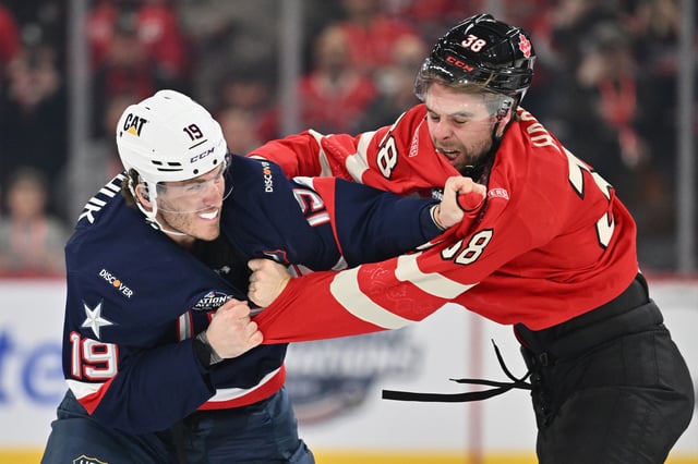 Matthew Tkachuk, No. 19 of Team USA, fights with Brandon Hagel, No. 38 of Team Canada, during the first period in the 4 Nations Face-Off game on Saturday.