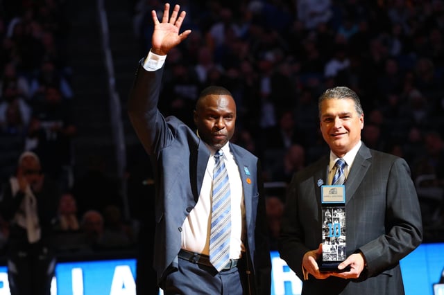 Feb 21, 2020; Orlando, Florida, USA; Orlando Magic player Darrell Armstrong is inducted into Orlando Magic Hall of Fame by CEO Alex Martins during the first half at Amway Center.