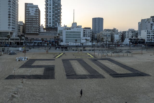 Relatives and supporters of Israelis held hostage by Hamas in Gaza mark 500 days of their captivity with the numbers 500 laid out on the beach in Tel Aviv, Israel, Monday, Feb. 17, 2025. (AP Photo/Oded Balilty)
