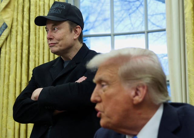 Elon Musk listens to U.S. President Donald Trump speak in the Oval Office of the White House in Washington, D.C., U.S., February 11, 2025.