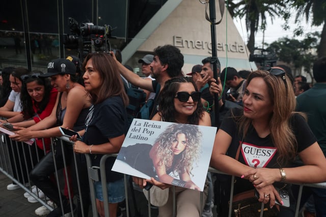A fan holds a poster of Colombian singer Shakira as they stand outside Clinica Delgado Auna after Shakira was hospitalized with a stomach issue, forcing her to cancel her Sunday show, in Lima, Peru February 16, 2025. REUTERS/Sebastian Castaneda/File Photo