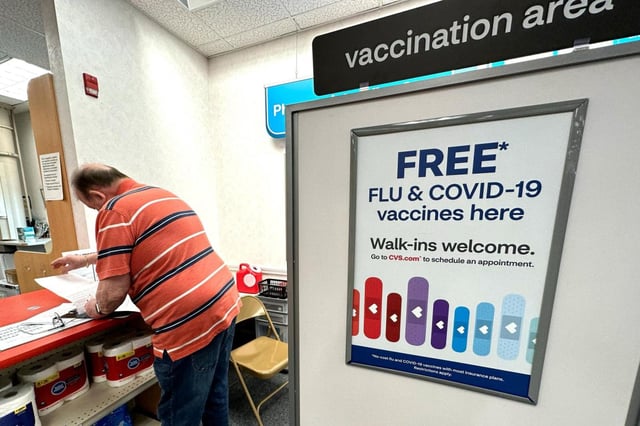 FILE – A sign for flu and covid vaccinations is displayed at a pharmacy store in Palatine, Ill., Wednesday, Sept. 13, 2023. The flu season in the U.S. is getting worse but it’s too soon to tell how much holiday gatherings contributed to a likely spike in illnesses. New government data posted Friday, Jan. 5, 2024 for the previous week _ the holiday week between Christmas and New Year’s _ show 38 states with high or very high levels for respiratory illnesses with fever, cough and other symptoms. That’s up from 31 states the week before. (AP Photo/Nam Y. Huh)