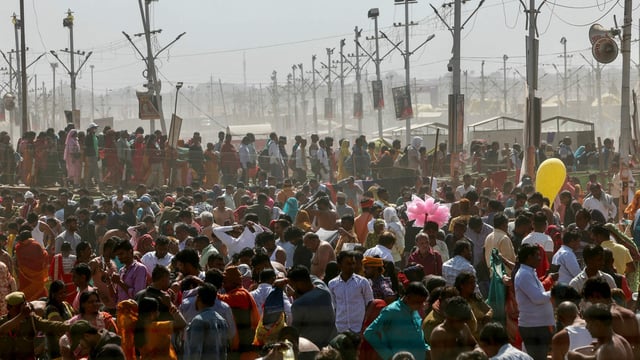 Hindu pilgrims gather to take a holy dip on the banks of the river Ganges during the ongoing Maha Kumbh Mela festival in Prayagraj on February 14, 2025.