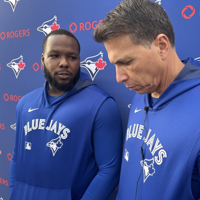 Toronto Blue Jays' Vladimir Guerrero Jr. talks to media in Dunedin, Fla. on Tuesday, Feb.18, 2025 as interpreter Hector Lebron looks on. Guerrero Jr. told reporters in Dunedin, Fla. that he and the team have not reached an agreement on a contract extension.THE CANADIAN PRESS/Greg Strong