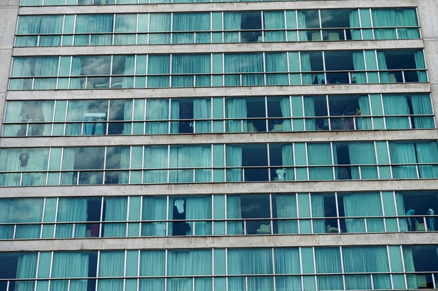 People look out from a hotel where migrants from Asia and the Middle East are housed after being deported to Panama as part of an agreement between the administration of U.S. President Donald Trump and the Central American nation, in Panama City, Panama February 18, 2025. REUTERS/Enea Lebrun