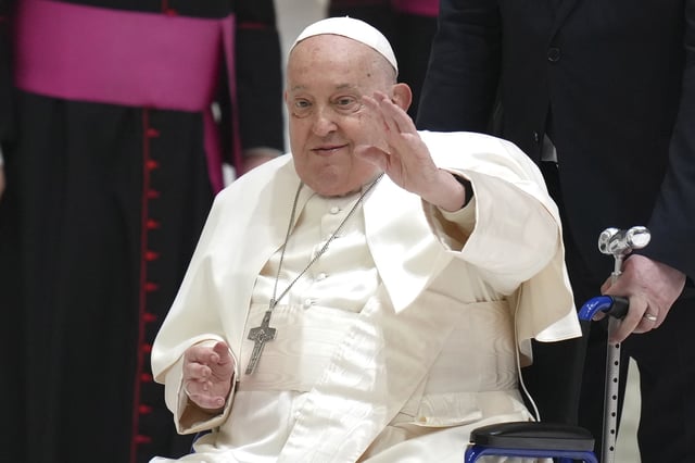 Pope Francis waves as he arrives for his weekly general audience in the Paul VI Hall, at the Vatican, Wednesday, February 12, 2025.