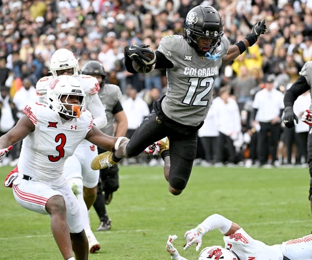 Colorado’s Travis Hunter, who won the Heisman Trophy as a two-way player, flies in to score a touchdown vs. Utah.(Cliff Grassmick/Boulder Daily Camera)