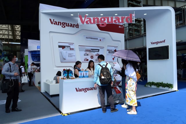 People are seen at a booth of Vanguard Group at a fair during the INCLUSION fintech conference in Shanghai, China September 24, 2020. REUTERS/Cheng Leng/File photo