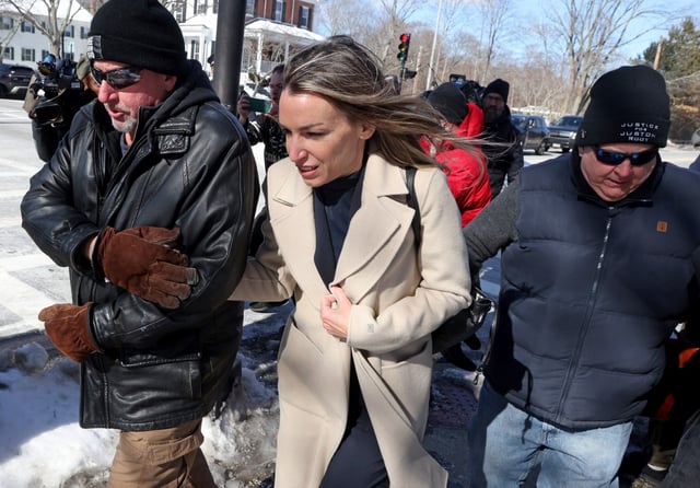 Karen Read, flanked by two security guards, leaves her hearing at Norfolk County Superior Court Tuesday.  (Matt Stone/Boston Herald)
