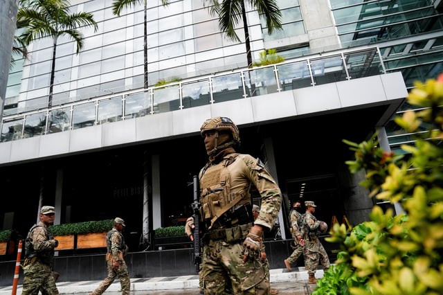 Members of Panama's National Aeronaval Service police (SENAN) stand outside the hotel where migrants from Asia and the Middle East are housed after being deported to Panama as part of an agreement between the administration of U.S. President Donald Trump and the Central American nation, in Panama City, Panama February 18, 2025. REUTERS/Enea Lebrun/File Photo