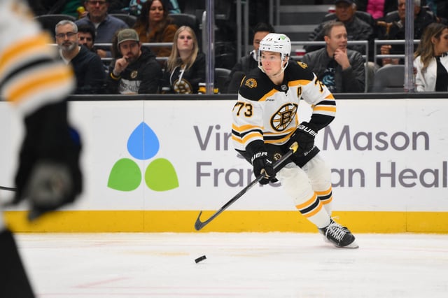 Dec 12, 2024; Seattle, Washington, USA; Boston Bruins defenseman Charlie McAvoy (73) plays the puck during the third period against the Seattle Kraken at Climate Pledge Arena. Mandatory Credit: Steven Bisig-Imagn Images/File Photo