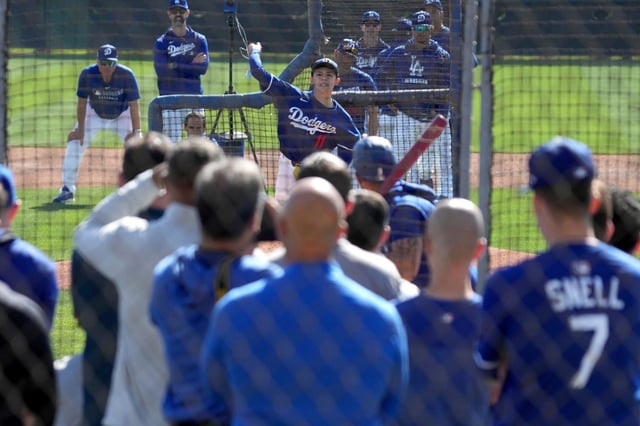 Dodgers pitcher Roki Sasaki throws in front of a crowd in his first time facing hitters at spring training Wednesday, Feb. 19, 2025, in Phoenix. (AP Photo/Darryl Webb)